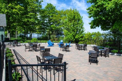 a patio with chairs and tables and blue chairs at The Lynx - 35 Butternut in Cherry Valley