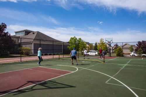 a group of people playing tennis on a tennis court at The Lynx - 35 Butternut in Cherry Valley