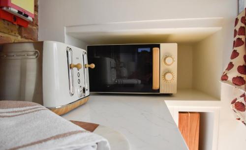 a microwave oven sitting on top of a kitchen counter at The Roost in Whitstable