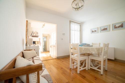 a kitchen and dining room with a table and chairs at The Roost in Whitstable