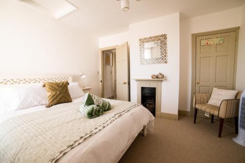 a bedroom with a large bed and a fireplace at The Roost in Whitstable