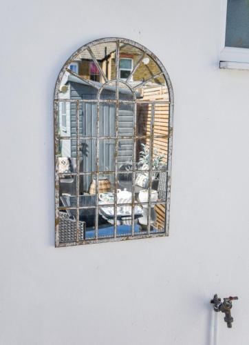 a mirror on the side of a wall at The Roost in Whitstable