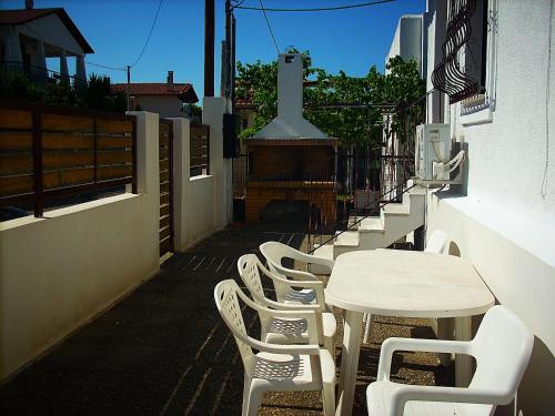 a table and chairs sitting next to a building at Sea view house II in Dhílesi