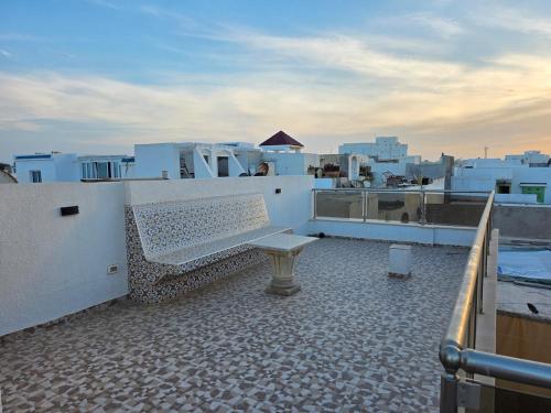 a bench sitting on top of a roof at American Style Triplex in Mahdia