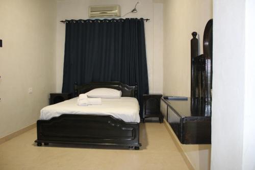 a bedroom with a bed with a black curtain at Hôtel Medina in Sousse