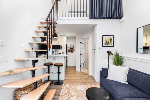 a living room with a blue couch and a spiral staircase at Covelet Hideaway in Blaine
