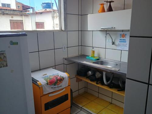 a small kitchen with a sink and a counter at Flats Mundos Pipa in Pipa
