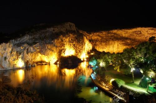 a view of a cave at night with lights at RELAX WITH SEA VIEW No 1!!!! in Varkiza