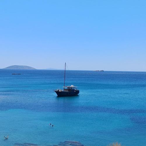 a boat in the middle of a large body of water at RELAX WITH SEA VIEW No 1!!!! in Varkiza