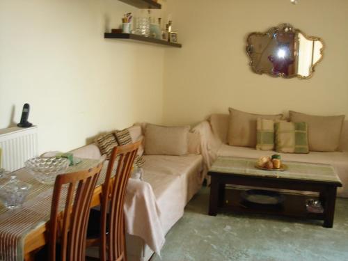 a living room with a couch and a table at RELAX WITH SEA VIEW No 1!!!! in Varkiza