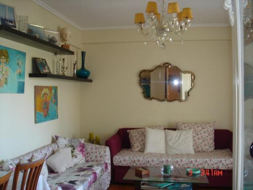 a living room with a couch and a mirror at RELAX WITH SEA VIEW No 1!!!! in Varkiza