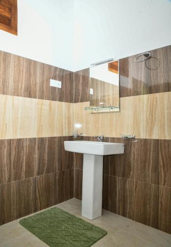 a bathroom with a sink and a mirror at EverGreen Resort Udawalawe in Udawalawe