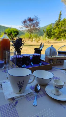 une table avec des assiettes et des bols sur une table dans l'établissement Chambres chez l'habitant, à Montbrun-les-Bains