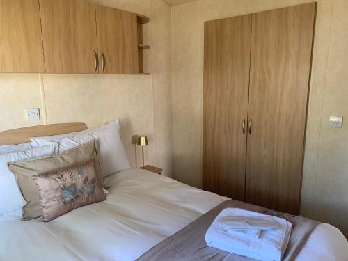 a bedroom with a white bed and wooden cabinets at Town View in Killarney