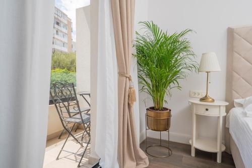 a bedroom with a plant in a pot next to a bed at Samstag Split in Split