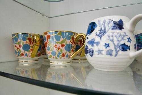 a group of vases sitting on a glass shelf at The Roost in Whitstable