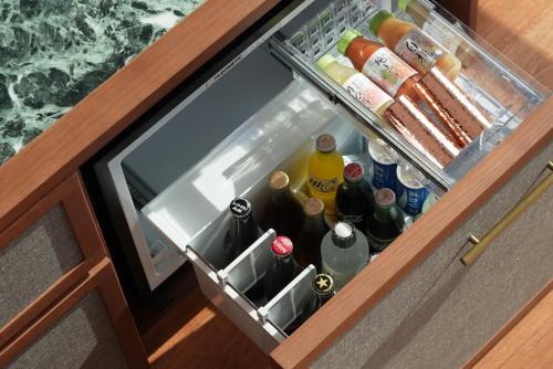 an open refrigerator filled with lots of drinks at One Fukuoka Hotel in Fukuoka