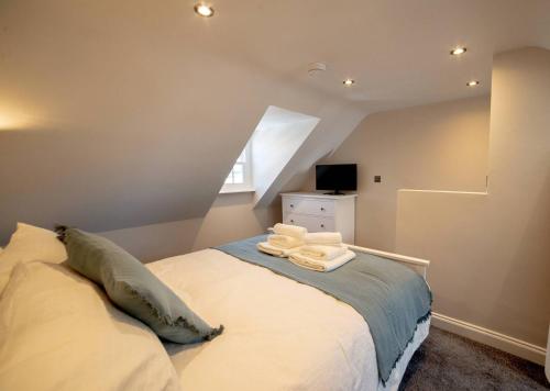 a bedroom with a bed in a attic at Holdens Cottage in Whitstable