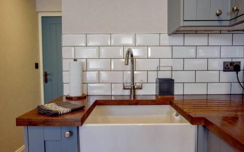 a kitchen with a sink and a counter top at Holdens Cottage in Whitstable