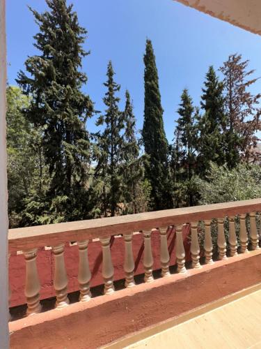 a balcony railing with trees in the background at La Palmeraie De Moulay Yacoub in Moulay Yacoub