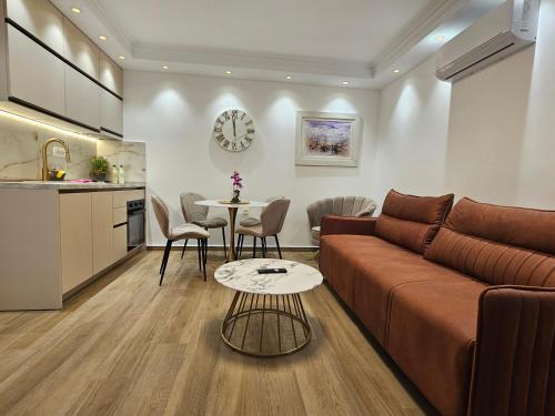 a living room with a couch and a table at Apartmani Nikic -Tivat in Tivat