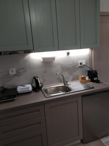 a kitchen with a sink and a counter top at Tennis Home-Pozar, Piperia! in Áno Rodoniá