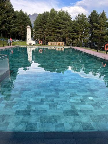 a large swimming pool with blue water at Casa Marali Ski & Bike Formigal in Formigal