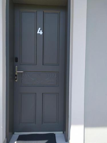 a door with the number four on it in a hallway at Tennis Home-Pozar, Piperia! in Áno Rodoniá