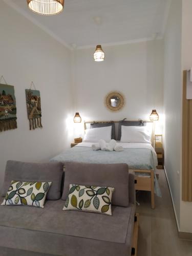 a bedroom with a large bed and a couch at Tennis Home-Pozar, Piperia! in Áno Rodoniá