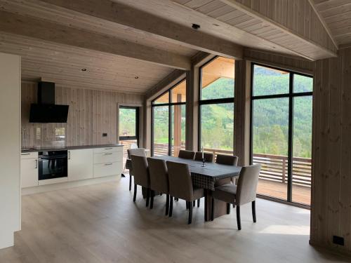 a kitchen and dining room with a table and chairs at Moderne og romslig familiehytte i Stryn in Stryn