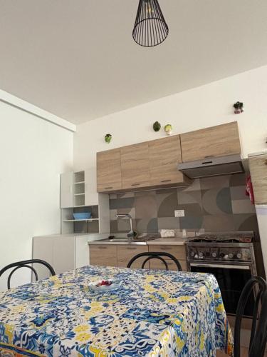 a kitchen with a table and chairs in a room at Casa Puccia in Pachino