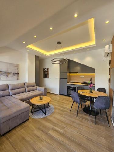 a living room with a couch and two tables at Apartmani Nikic -Tivat in Tivat