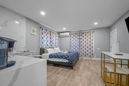 a bedroom with a bed and a tv in a room at Tranquil Escape- Spa Bath & Pool for One or Couples in Houston