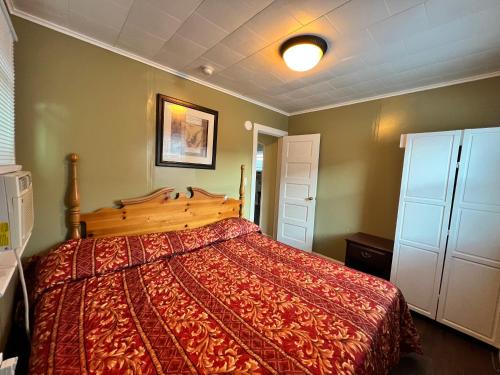 a bedroom with a bed with a red comforter at Shore Beach Houses - 38 D Lincoln Avenue in Seaside Heights