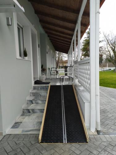 a metal mat on the front porch of a house at Tennis Home-Pozar, Piperia! in Áno Rodoniá