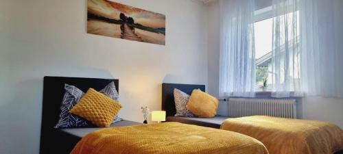 a bedroom with two beds and a window at 3-room apartment Linz in Linz