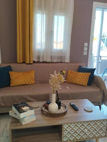 a living room with a couch and a coffee table at Thanos Cozy Apartments in Skala Kallonis