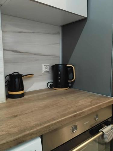 a kitchen counter with two coffee pots on it at Thanos Cozy Apartments in Skala Kallonis