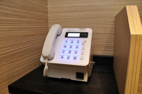 a cell phone is sitting on top of a table at Sotetsu Fresa Inn Ginza-Nanachome in Tokyo