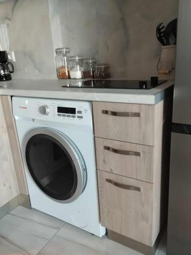 a kitchen with a washing machine and a counter at Thanos Cozy Apartments in Skala Kallonis