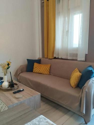 a living room with a couch and a coffee table at Thanos Cozy Apartments in Skala Kallonis