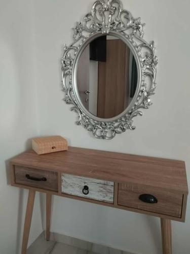 a mirror sitting on top of a wooden dresser at Thanos Cozy Apartments in Skala Kallonis