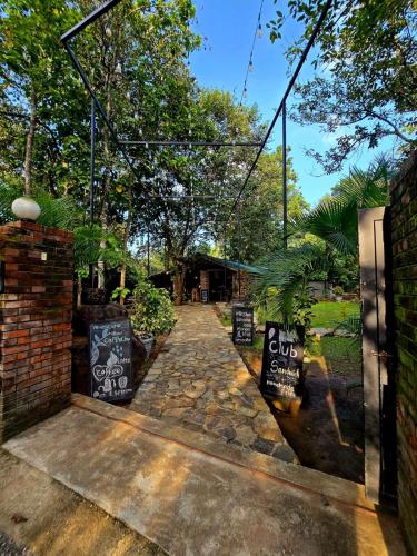 a walkway with a sign that says club at La Dolce Vita in Sigiriya