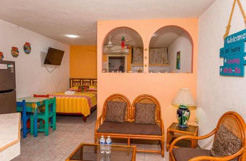a room with a kitchen and a living room at Hotel Maria's Nicte Ha in Progreso