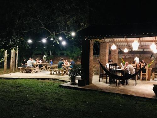 a group of people sitting at tables at a restaurant at night at La Dolce Vita in Sigiriya