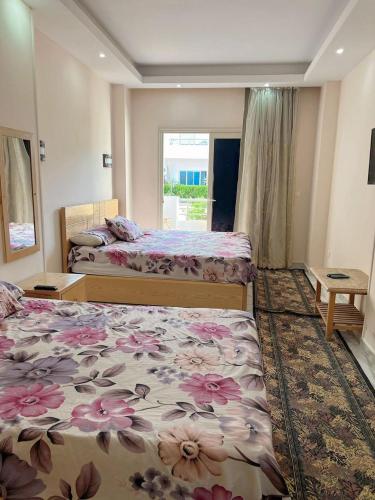 a hotel room with two beds and a window at Cecilia Resort in Hurghada