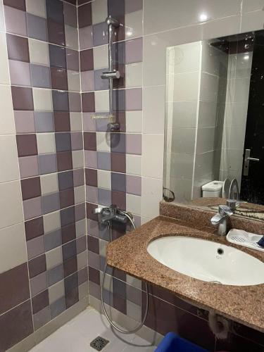 a bathroom with a sink and a shower at Cecilia Resort in Hurghada