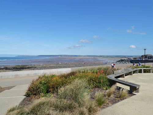 a bench on a beach with the ocean in the background at Torridge in Great Torrington