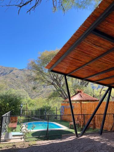 a pavilion with a swimming pool in a yard at Casa Lalina in Laprida