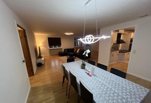 a dining room and living room with a table with chairs at Waves & Waterslides in Rødby